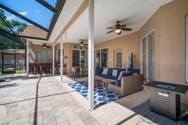 2903 Manor Ridge Pl, Valrico, FL 33596 - view of patio / terrace featuring a ceiling fan, an outdoor living space with a fire pit, and glass enclosure