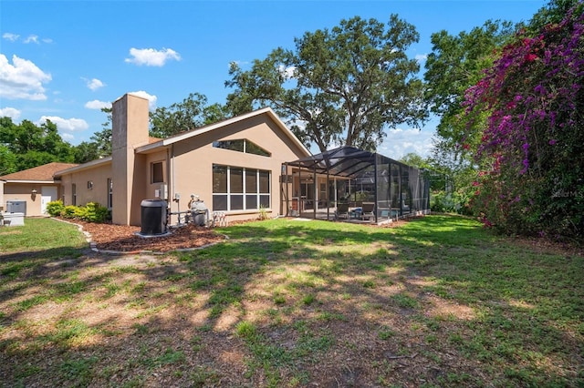 2903 Manor Ridge Pl, Valrico, FL 33596 - rear view of house with stucco siding, a chimney, a yard, and a lanai