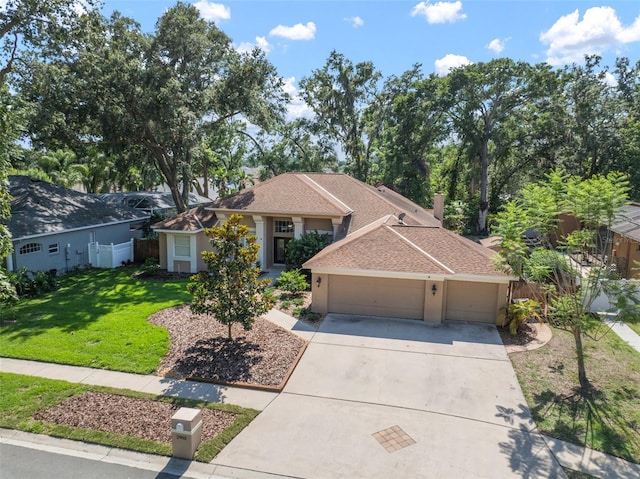 2903 Manor Ridge Pl, Valrico, FL 33596 - view of front of house with an attached garage, concrete driveway, a front lawn, and stucco siding