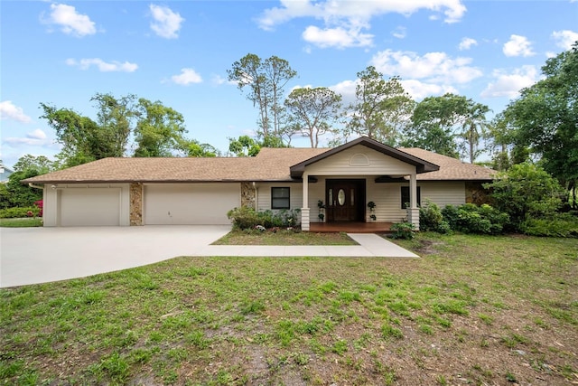 8011 N Mobley Rd, Odessa, FL 33556 - ranch-style house with a garage, a front lawn, concrete driveway, and a porch