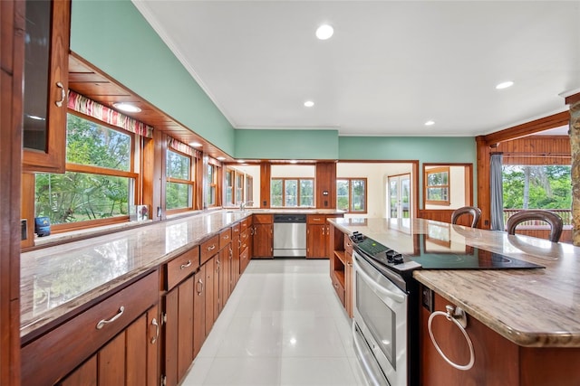 8011 N Mobley Rd, Odessa, FL 33556 - kitchen featuring stainless steel appliances, ornamental molding, light tile patterned floors, light stone counters, and brown cabinetry