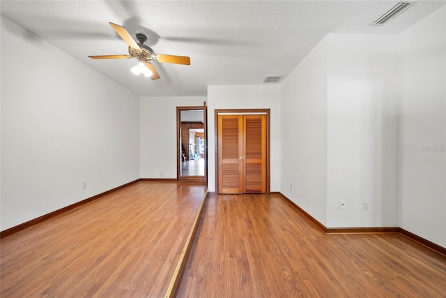 8011 N Mobley Rd, Odessa, FL 33556 - unfurnished bedroom with wood finished floors, baseboards, a closet, and a ceiling fan