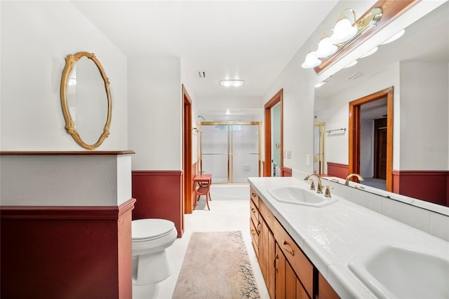 8011 N Mobley Rd, Odessa, FL 33556 - full bath with toilet, double vanity, and combined bath / shower with glass door