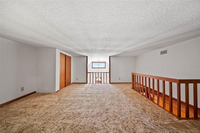 8011 N Mobley Rd, Odessa, FL 33556 - empty room featuring carpet floors, baseboards, and a textured ceiling
