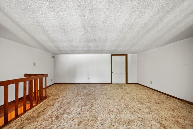 8011 N Mobley Rd, Odessa, FL 33556 - additional living space featuring a textured ceiling, carpet flooring, and baseboards