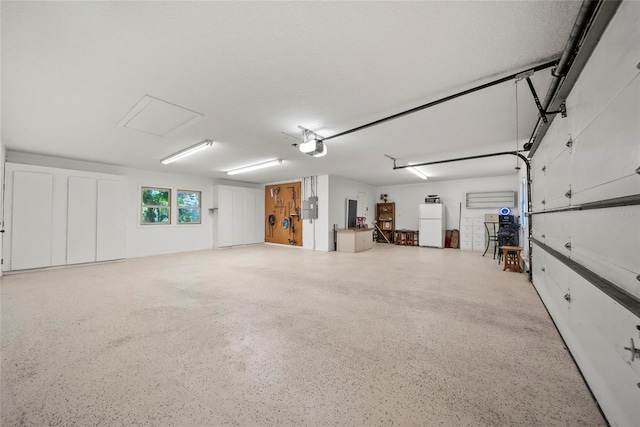 8011 N Mobley Rd, Odessa, FL 33556 - garage featuring freestanding refrigerator and a garage door opener