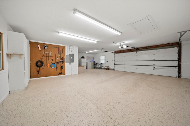 8011 N Mobley Rd, Odessa, FL 33556 - garage with electric panel, a garage door opener, and freestanding refrigerator