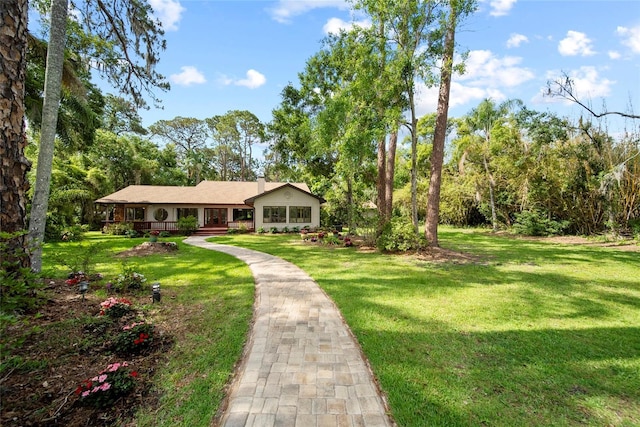 8011 N Mobley Rd, Odessa, FL 33556 - view of front of house featuring a front yard and a chimney