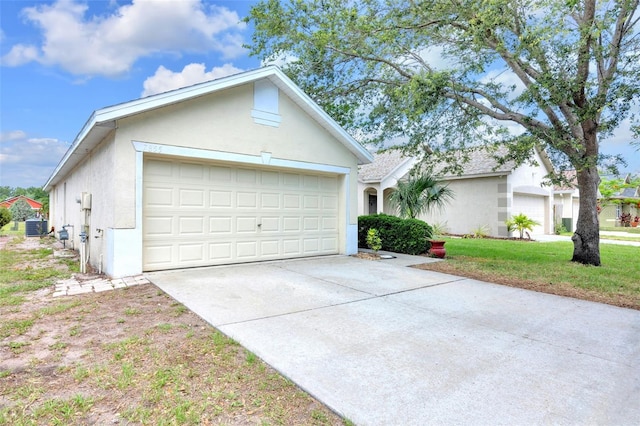 view of front facade featuring stucco siding, concrete driveway, and an attached garage