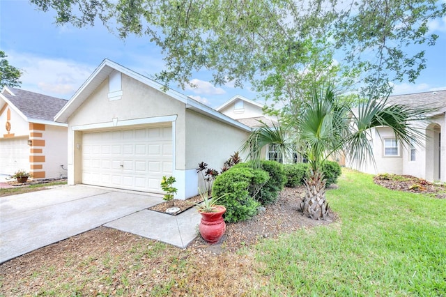 view of front of property with a garage, concrete driveway, stucco siding, and a front yard