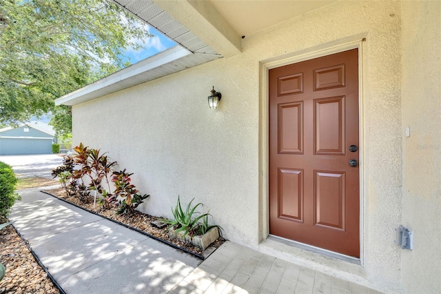 view of exterior entry featuring stucco siding