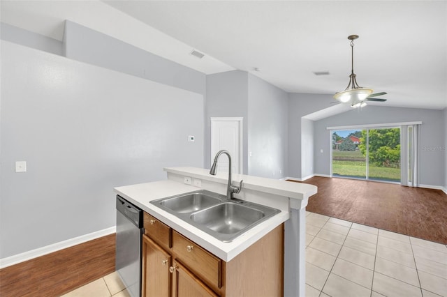 kitchen with dishwasher, a sink, light tile patterned floors, open floor plan, and light countertops
