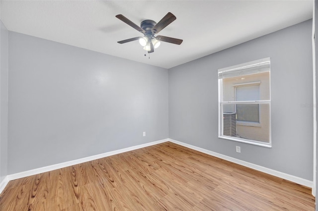 empty room with baseboards, light wood-type flooring, and ceiling fan