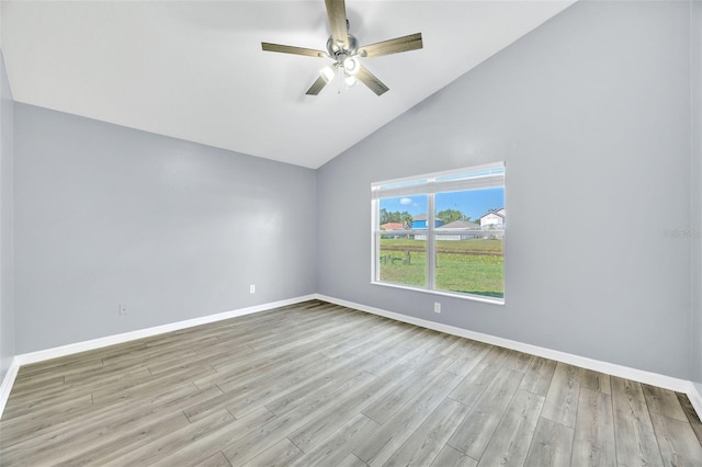 unfurnished room featuring wood finished floors, baseboards, a ceiling fan, and high vaulted ceiling
