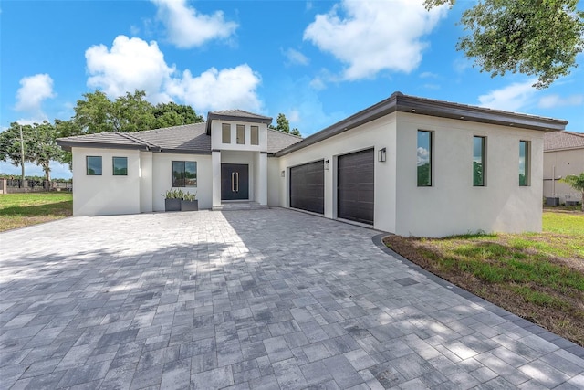 11921 Fort King Hwy, Thonotosassa, FL 33592 - prairie-style home with an attached garage, decorative driveway, and stucco siding