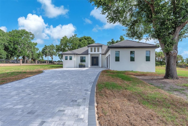 11921 Fort King Hwy, Thonotosassa, FL 33592 - view of front facade with stucco siding, decorative driveway, and a front lawn