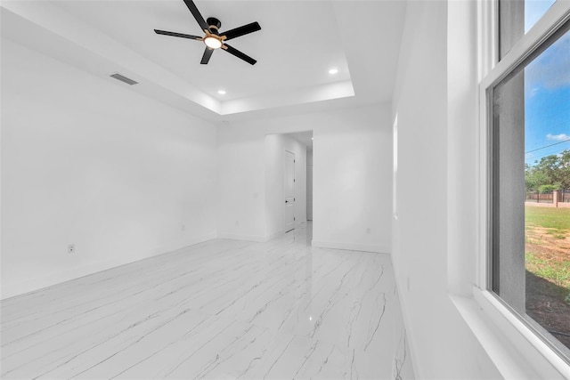 11921 Fort King Hwy, Thonotosassa, FL 33592 - empty room with recessed lighting, baseboards, ceiling fan, light marble finish flooring, and a tray ceiling