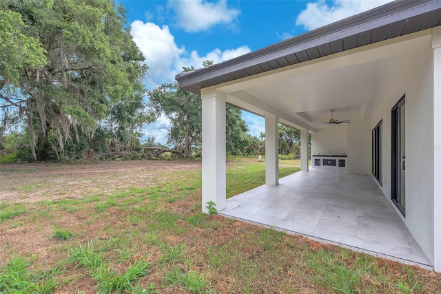 11921 Fort King Hwy, Thonotosassa, FL 33592 - view of green lawn featuring ceiling fan and a patio