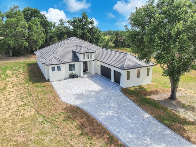 11921 Fort King Hwy, Thonotosassa, FL 33592 - view of front of house featuring an attached garage, decorative driveway, stucco siding, and a front yard