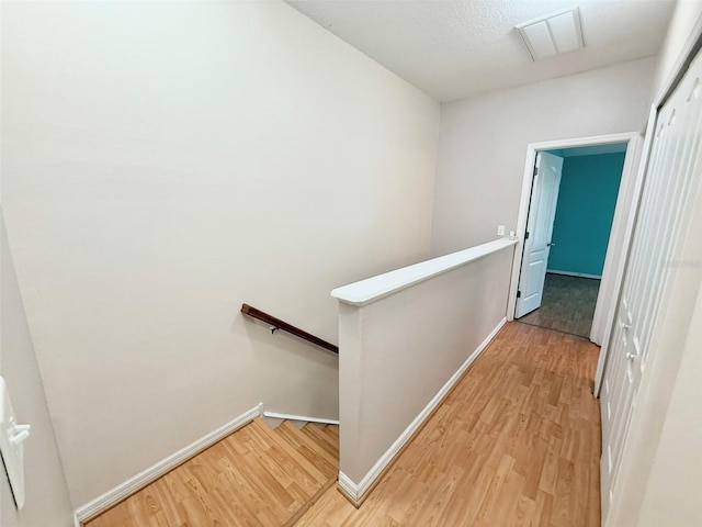 15922 Fishhawk Creek Ln, Lithia, FL 33547 - hall with an upstairs landing, wood finished floors, and baseboards