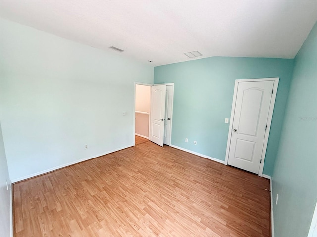 15922 Fishhawk Creek Ln, Lithia, FL 33547 - unfurnished bedroom featuring light wood-type flooring, baseboards, and lofted ceiling