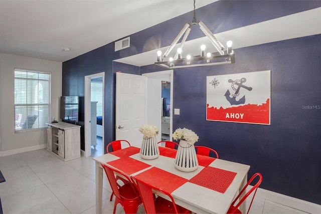 1230 S Missouri Ave Unit 704, Clearwater, FL 33756 - dining area featuring a chandelier, baseboards, and light tile patterned flooring