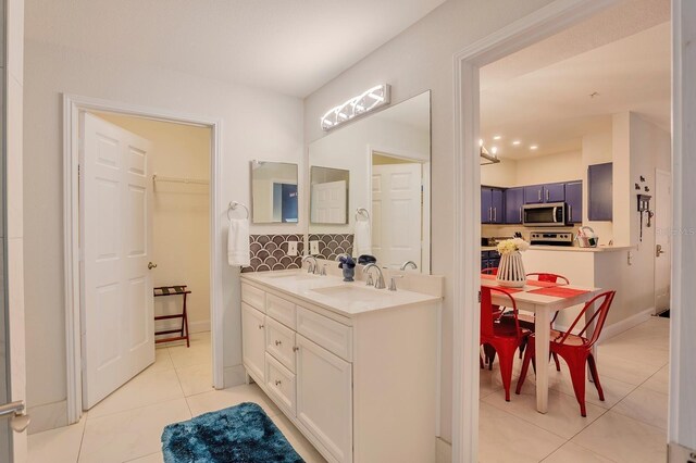 1230 S Missouri Ave Unit 704, Clearwater, FL 33756 - bathroom with tile patterned floors, double vanity, and baseboards