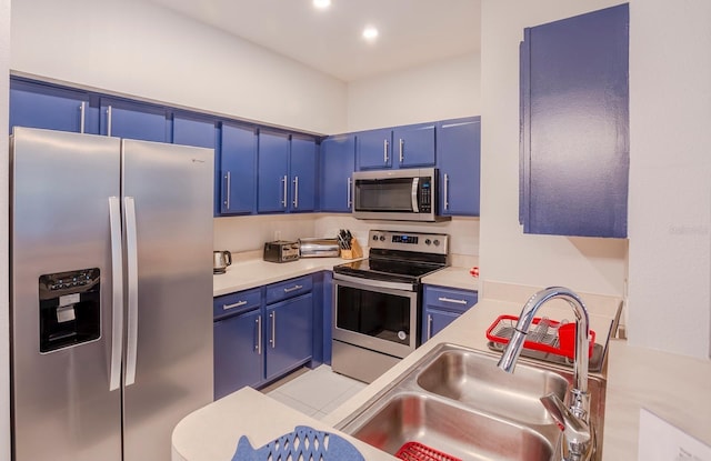 1230 S Missouri Ave Unit 704, Clearwater, FL 33756 - kitchen featuring stainless steel appliances, blue cabinetry, a sink, light countertops, and recessed lighting