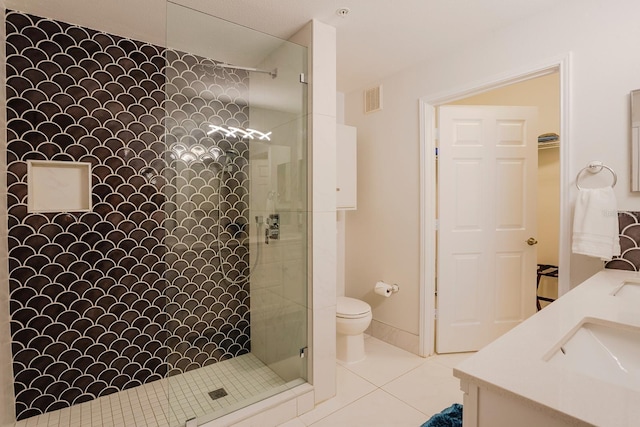 1230 S Missouri Ave Unit 704, Clearwater, FL 33756 - bathroom with tiled shower, toilet, double vanity, and tile patterned floors