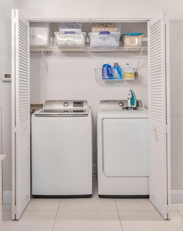 1230 S Missouri Ave Unit 704, Clearwater, FL 33756 - washroom featuring washer and clothes dryer and light tile patterned floors