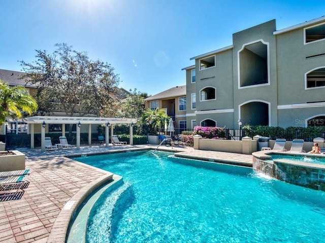 1230 S Missouri Ave Unit 704, Clearwater, FL 33756 - view of swimming pool featuring a pergola, a pool with connected hot tub, and a patio