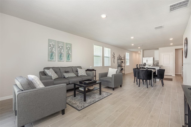 7119 Amelia River Dr, Parrish, FL 34219 - living room featuring light wood finished floors, recessed lighting, and baseboards