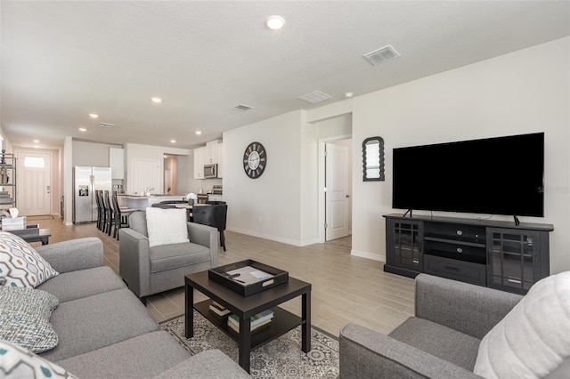 7119 Amelia River Dr, Parrish, FL 34219 - living room featuring light wood-style floors, baseboards, and recessed lighting