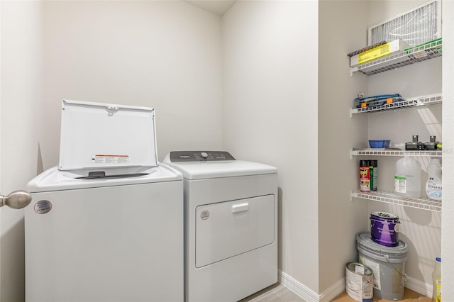 7119 Amelia River Dr, Parrish, FL 34219 - laundry area with washing machine and clothes dryer and baseboards