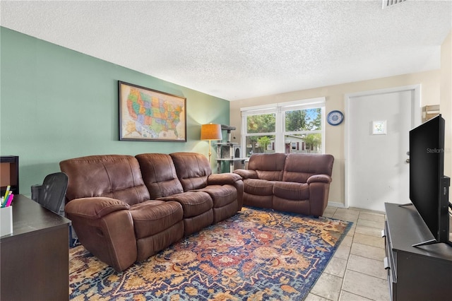 2646 61st Ave N, Saint Petersburg, FL 33714 - living room featuring a textured ceiling and light tile patterned flooring