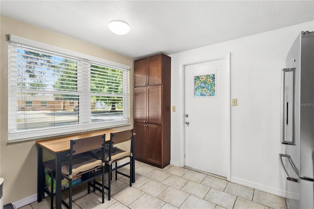 2646 61st Ave N, Saint Petersburg, FL 33714 - foyer with a textured ceiling, baseboards, and light tile patterned floors