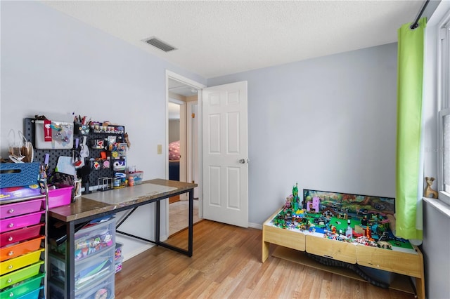 2646 61st Ave N, Saint Petersburg, FL 33714 - bedroom with wood finished floors and a textured ceiling