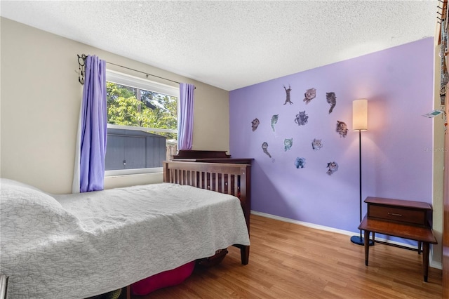 2646 61st Ave N, Saint Petersburg, FL 33714 - bedroom featuring wood finished floors, a textured ceiling, and baseboards