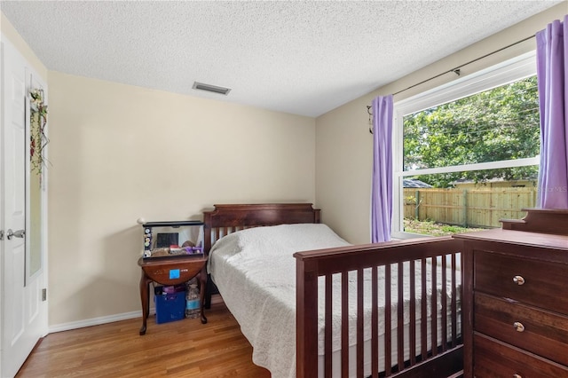 2646 61st Ave N, Saint Petersburg, FL 33714 - bedroom with wood finished floors, baseboards, and a textured ceiling