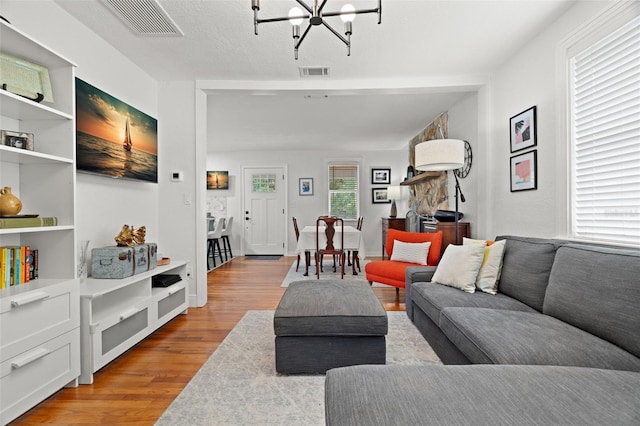 1003 W Indiana Ave, Tampa, FL 33603 - living area featuring light wood-type flooring and a chandelier
