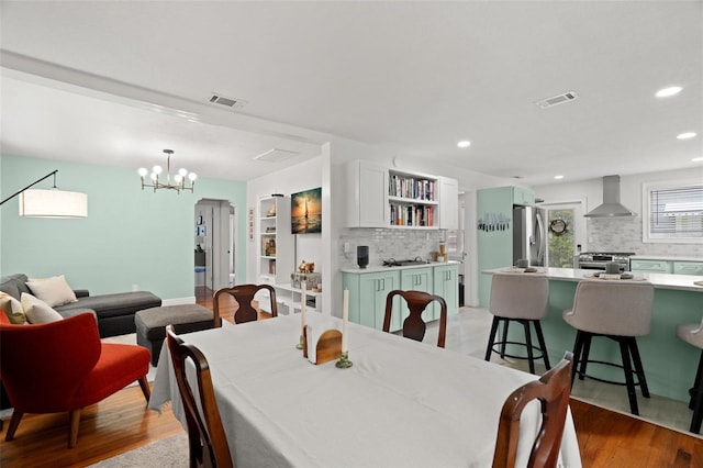 1003 W Indiana Ave, Tampa, FL 33603 - dining room with recessed lighting, a chandelier, and light wood-type flooring