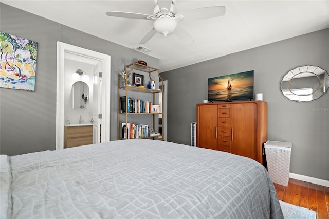 1003 W Indiana Ave, Tampa, FL 33603 - bedroom with wood finished floors, ensuite bathroom, and a ceiling fan