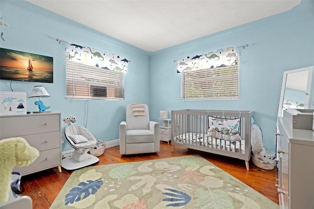 1003 W Indiana Ave, Tampa, FL 33603 - bedroom with wood finished floors and a nursery area
