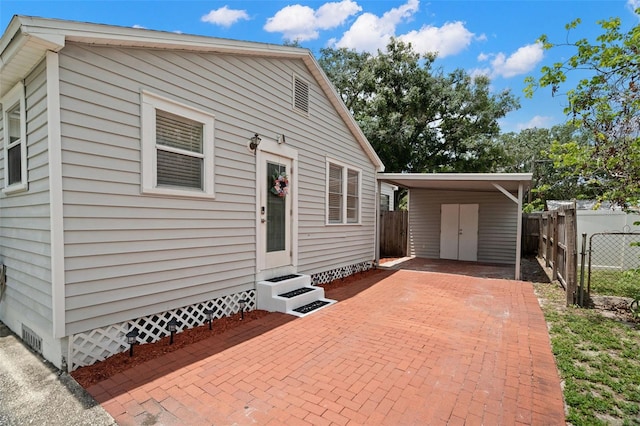 1003 W Indiana Ave, Tampa, FL 33603 - view of side of property with entry steps and a carport