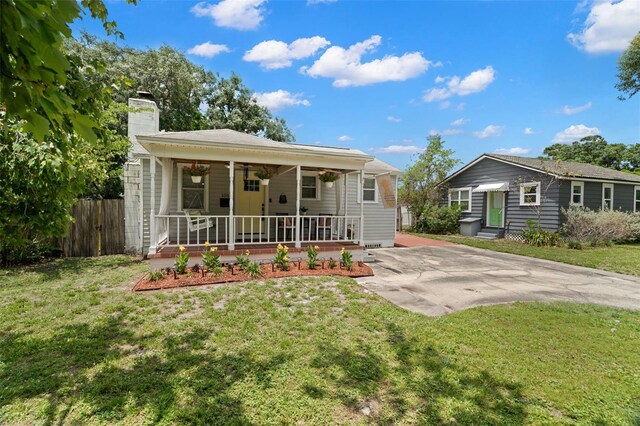 1003 W Indiana Ave, Tampa, FL 33603 - back of house featuring a chimney and a porch