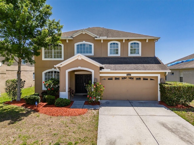 7852 Stoney Hill Dr, Wesley Chapel, FL 33545 - traditional-style house with driveway, stucco siding, an attached garage, and a shingled roof