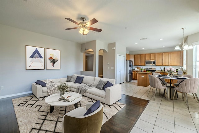 7852 Stoney Hill Dr, Wesley Chapel, FL 33545 - living room with arched walkways, a ceiling fan, a chandelier, light wood-type flooring, and recessed lighting