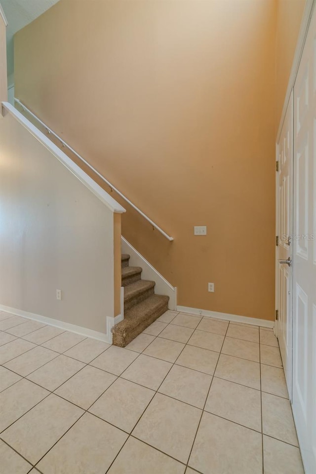 7852 Stoney Hill Dr, Wesley Chapel, FL 33545 - entrance foyer with light tile patterned floors, stairs, and baseboards