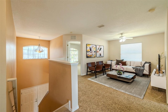 7852 Stoney Hill Dr, Wesley Chapel, FL 33545 - carpeted living room featuring healthy amount of natural light, a ceiling fan, and baseboards