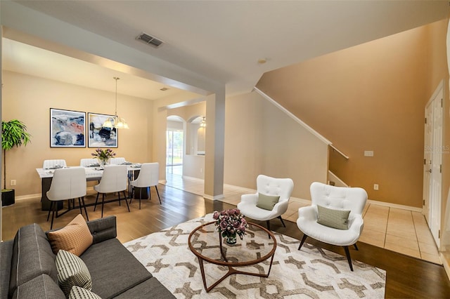 7852 Stoney Hill Dr, Wesley Chapel, FL 33545 - living room with arched walkways, stairway, wood finished floors, and baseboards